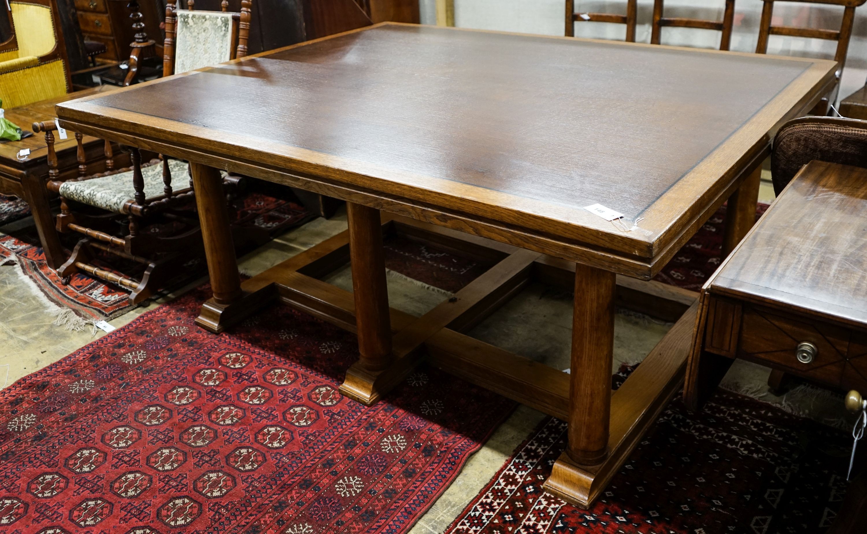 A large rectangular oak dining or boardroom table on six column supports (From The Wills Cigarette Factory, Newcastle), length 182cm, depth 152cm, height 77cm